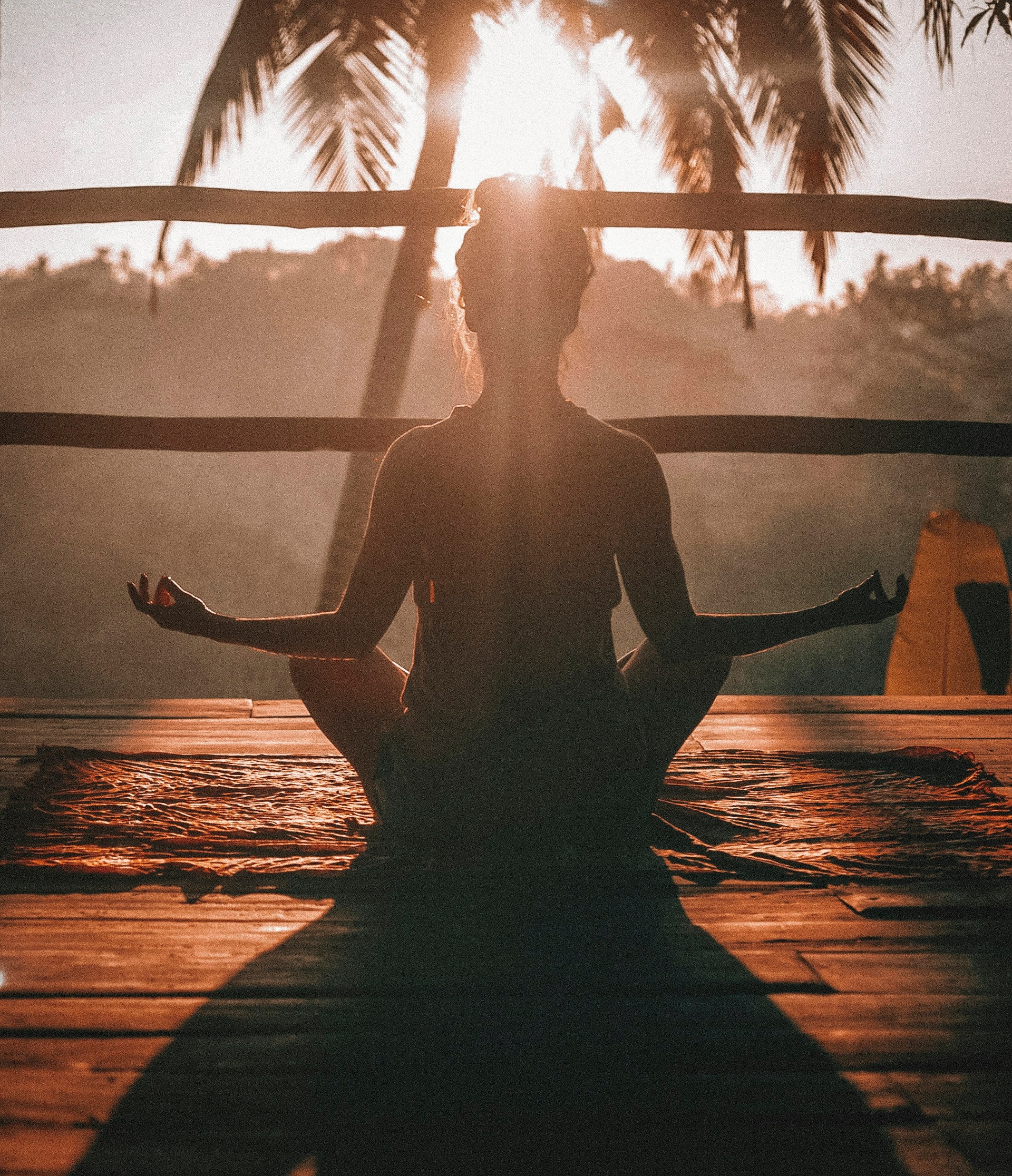 Person meditating outdoors representing stress reduction and recovery.